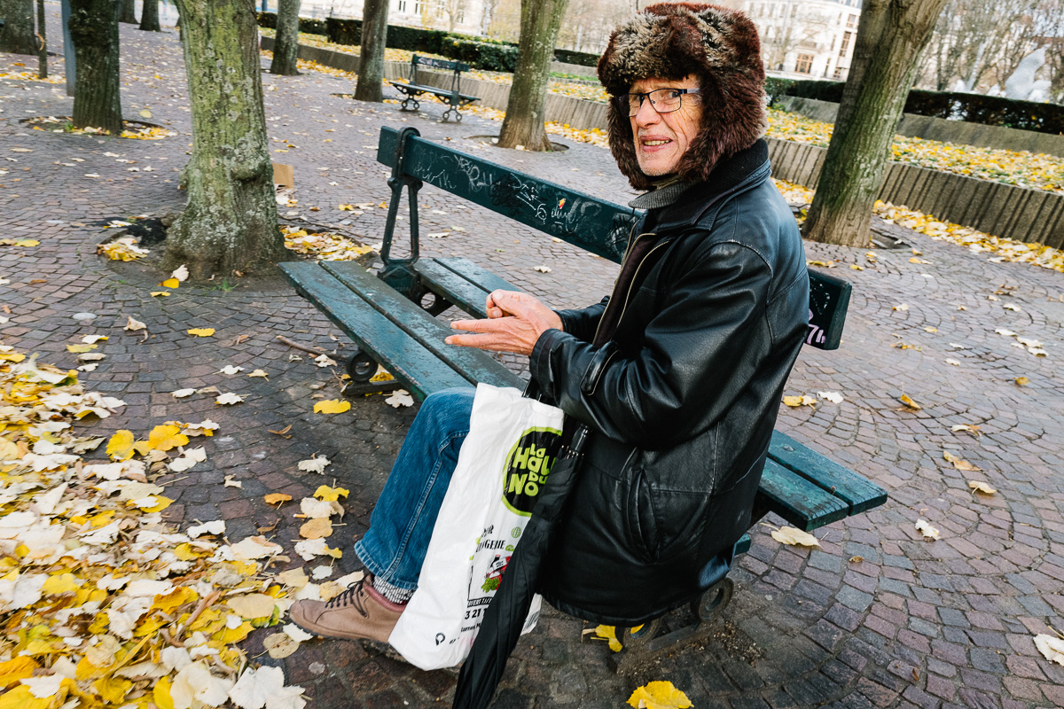 Un homme assis sur un banc près de Palais des Beaux Arts de Lille avec un couteau Opinel dans la main